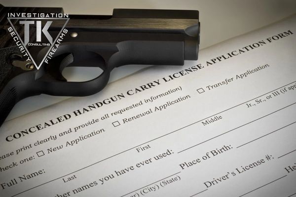 A gun sitting on top of an application form.